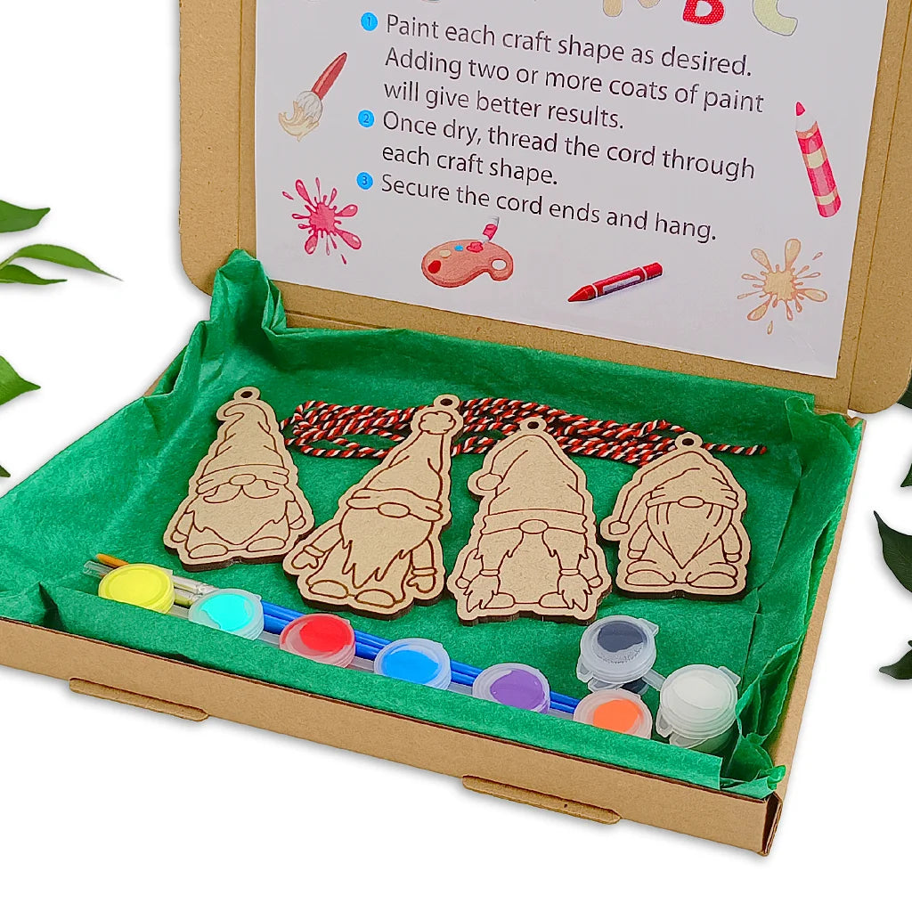 Wooden gnome shapes with paint supplies in a box