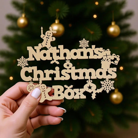 bold font christmas box topper held in hand