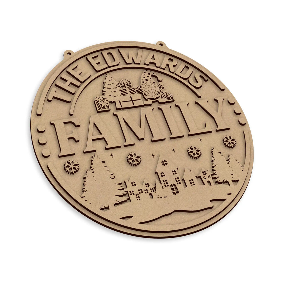 A round, personalised laser-cut wooden plaque with a winter landscape design on a plain white background.