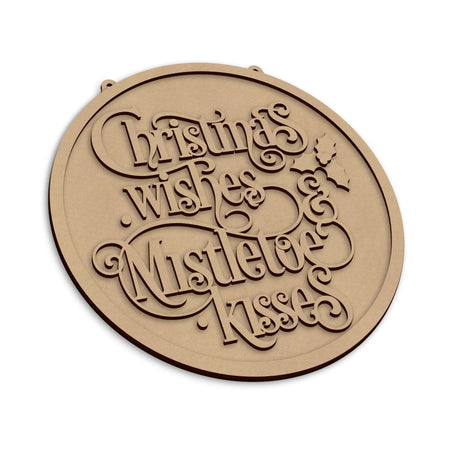 An round wooden plaque with laser-cut text reading 'Christmas wishes and Mistletoe Kisses' on a plain white background.