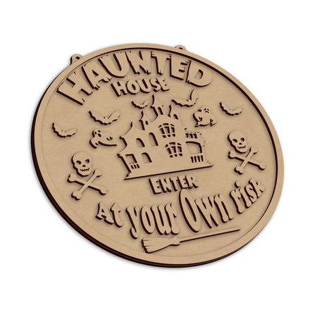 A round, Haunted House Halloween sign, with the text 'HAUNTED HOUSE ENTER AT YOUR OWN RISK'.