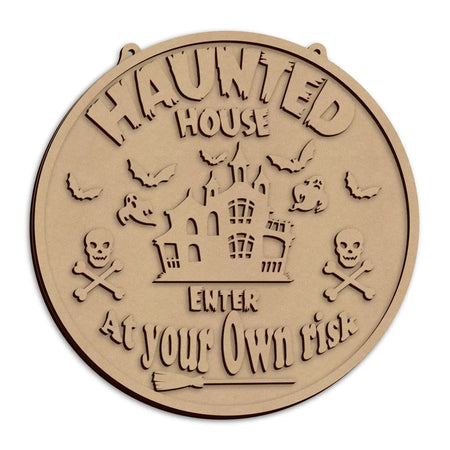 A round wooden Halloween sign with the text 'HAUNTED HOUSE ENTER AT YOUR OWN RISK'.