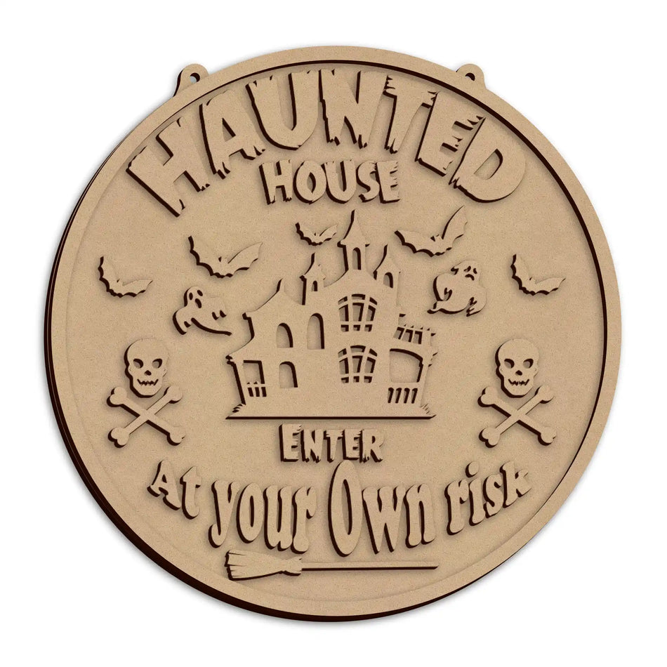 A round wooden Halloween sign with the text 'HAUNTED HOUSE ENTER AT YOUR OWN RISK'.
