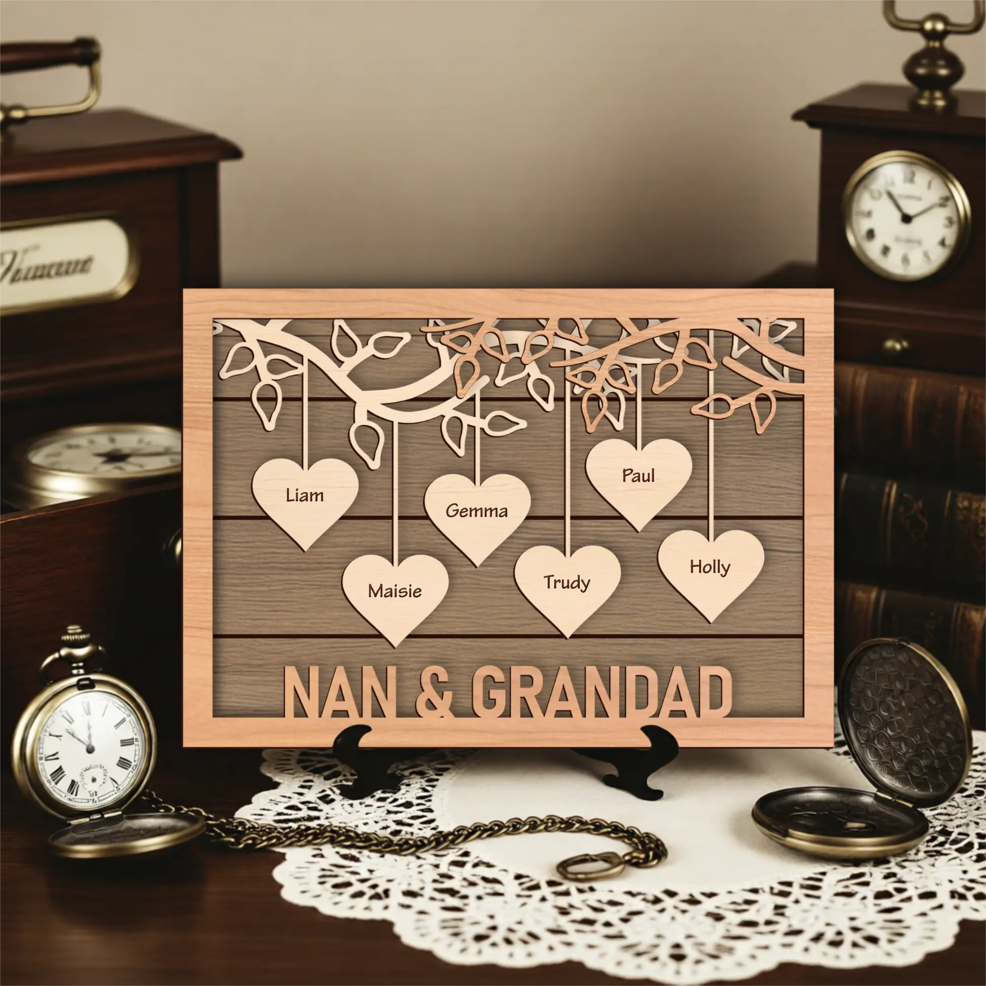 Wooden plaque with cut-out hearts and engraved names, placed on a decorative surface with vintage items.