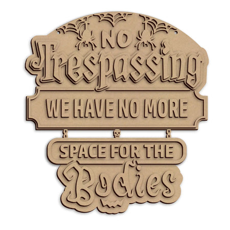 A laser-cut wooden Halloween sign with 'NO Trespassing WE HAVE NO MORE SPACE FOR THE Bodies', shown on a plain white background.