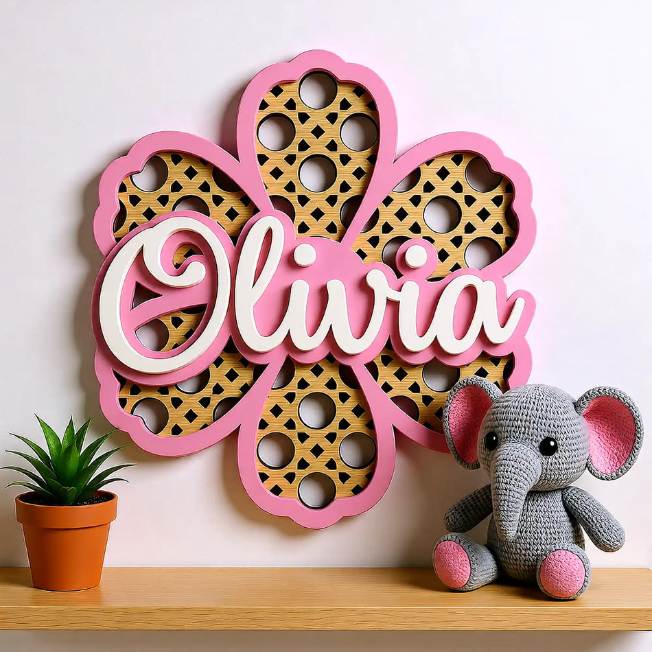 Wooden floral name plaque styled on nursery wall in neutral baby room UK
