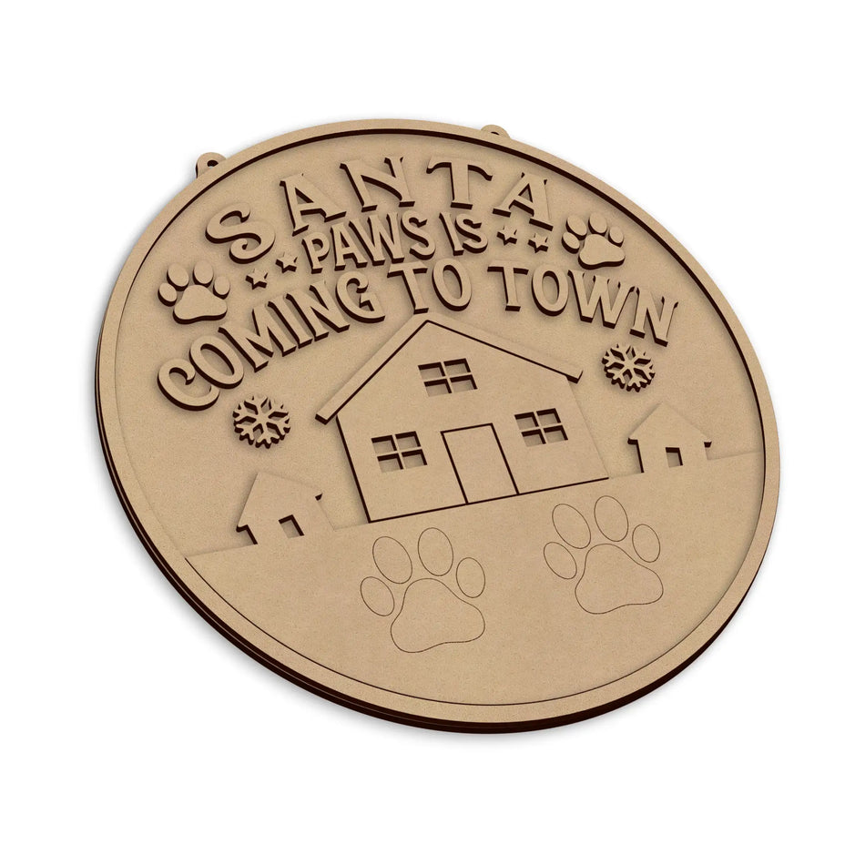 An round wooden plaque with a laser-cut design featuring the text 'Santa Paws Is Coming To Town', shown on a plain white background.