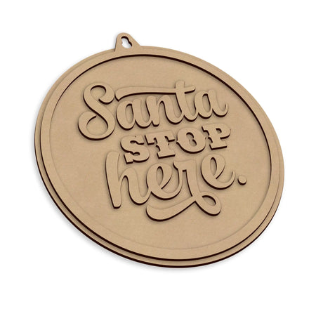 A round, wooden Christmas sign with the words 'Santa STOP here.' on a plain white background.