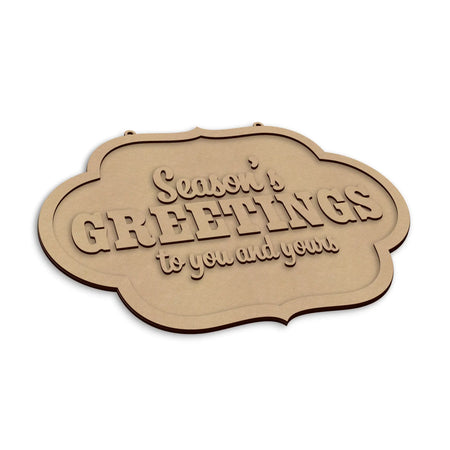 A wooden sign with the words 'Season's Greetings to you and yours' in raised lettering, shown on a plain white background.