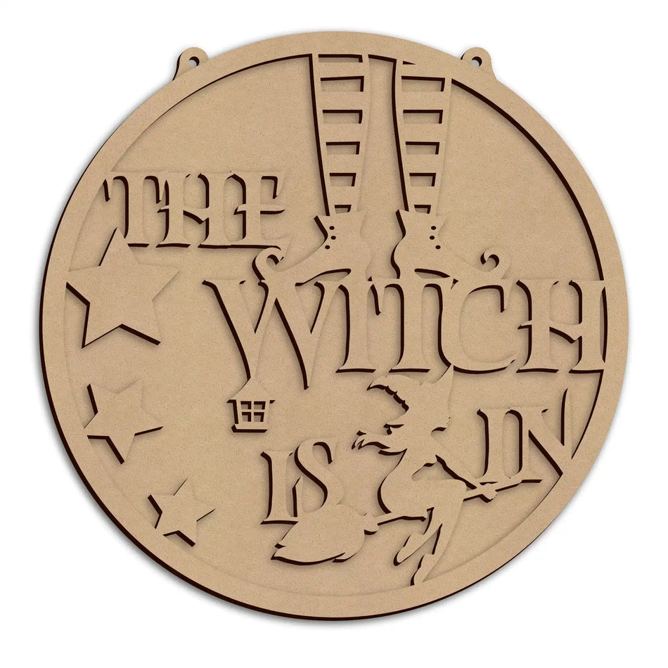 A round laser-cut halloween wall plaque, featuring the text 'The Witch Is In', shown on a plain white background.